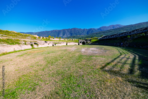 Roman amphitheater in the village of Avella, Italy. A beautiful sunny day with fairy-tale clouds in the background