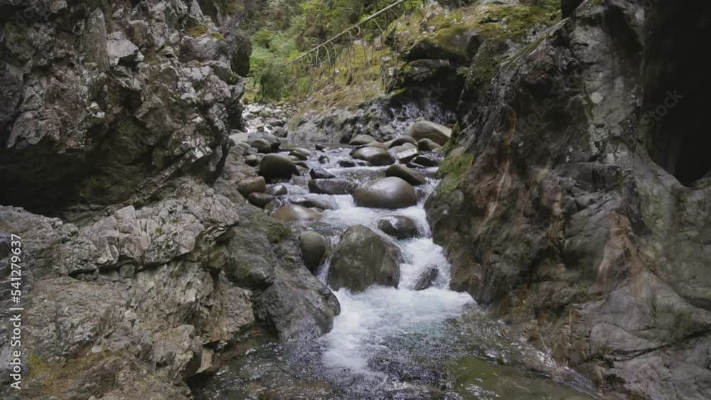 Fresh Water running down the water fall around rocks in Canadian Nature. Lynn Valley Canyons, North Vancouver, British Columbia, Canada. 4k Cinematic Slow Motion Fresh Water running down the water fall around rocks in Canadian Nature. Lynn Valley Canyons, North Vancouver, British Columbia, Canada. 4k Cinematic Slow Motion