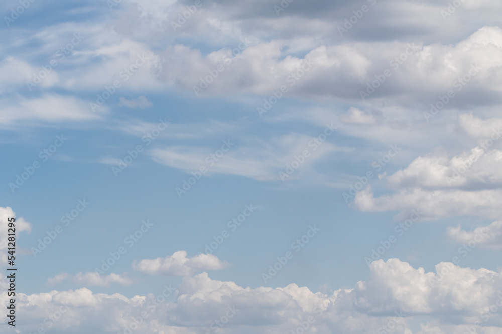 White clouds on the blue sky, bright background of the summer sky. White clouds on the blue sky, bright background of the summer sky.