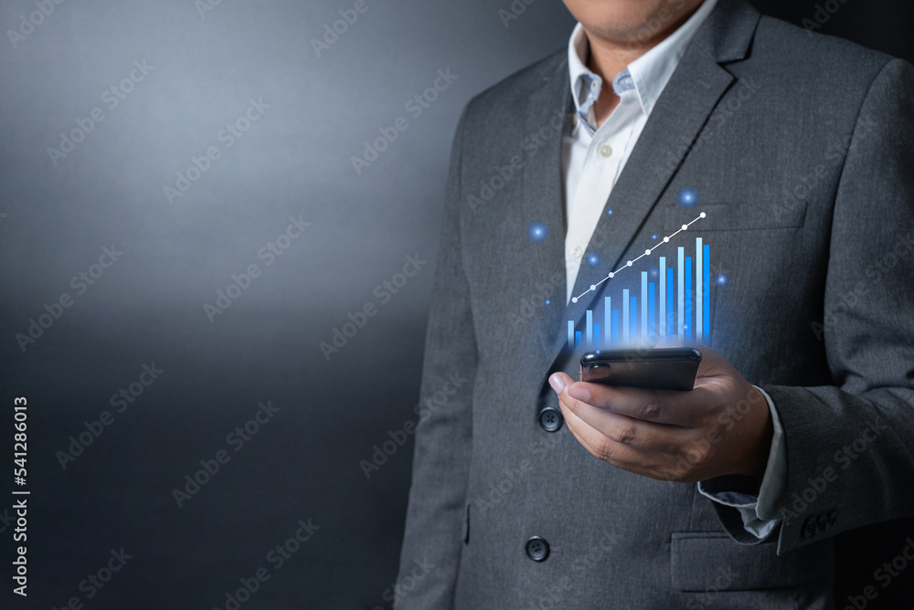 Close up businessman pushing, touching on smartphone with virtual emotion icon on black and gray background Close up businessman pushing, touching on smartphone with virtual emotion icon on black and gray background