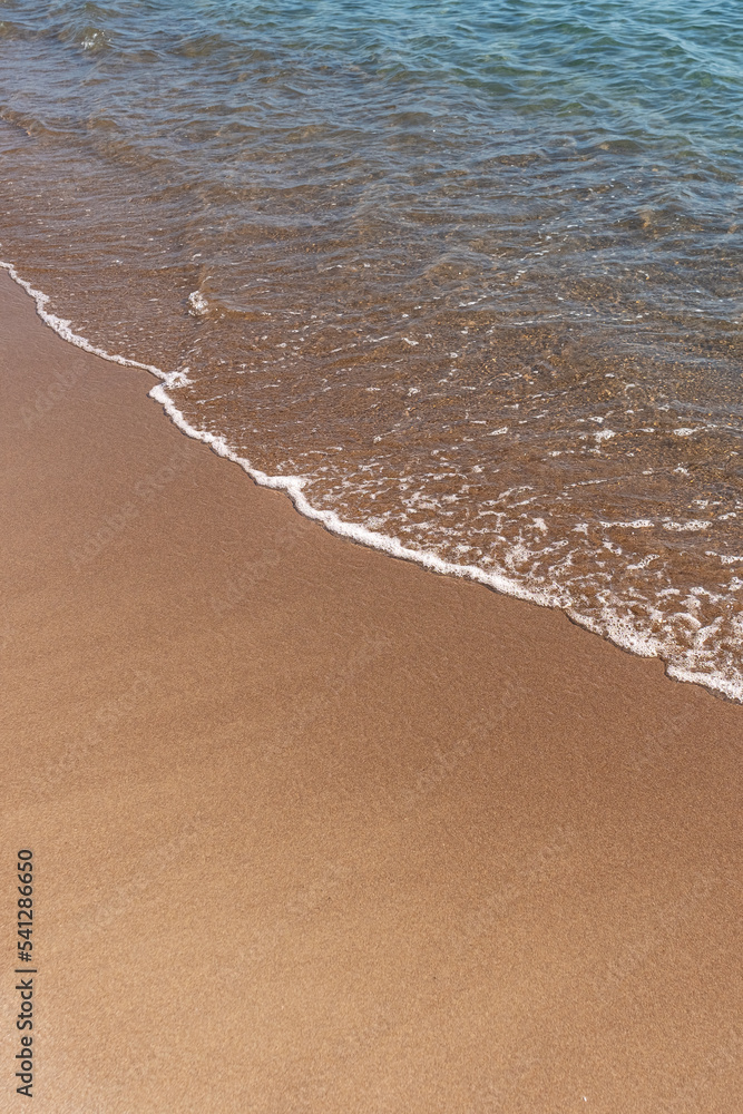 Sand beach and Blue ocean with soft wave form on Sand Texture,Seaside view of Brown Beach sand dune in sunny day Spring, Vertical top view for Summer banner background. Sand beach and Blue ocean with soft wave form on Sand Texture,Seaside view of Brown Beach sand dune in sunny day Spring, Vertical top view for Summer banner background.