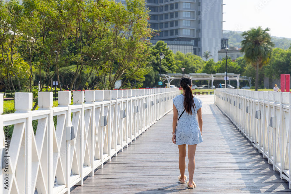 Woman walk on the wooden bridge walkway in Bali of Taiwan Woman walk on the wooden bridge walkway in Bali of Taiwan