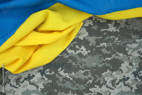 Universal army camouflage. Camouflage of the Armed Forces of Ukraine and flag. photo