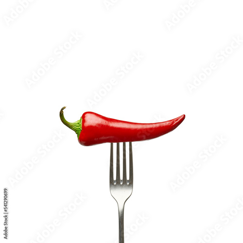 Hot pepper stuffed on a fork on a white background © piotrszczepanek