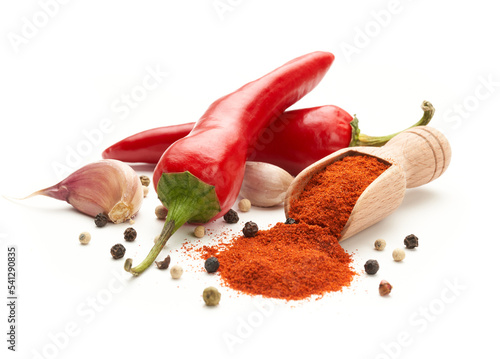 Hot red pepper ground on a white background. Whole hot peppers