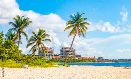 Tableau sur toile Palms parasols sun loungers beach resort Playa del Carmen Mexico.