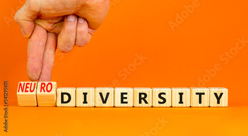 Diversity or neurodiversity symbol. Concept words Diversity and Neurodiversity on wooden cubes. Doctor hand. Beautiful orange background. Medical diversity or neurodiversity concept. Copy space. photo