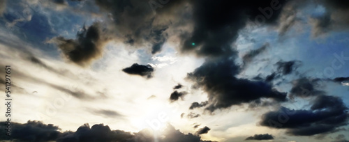 Beautiful sunset sky, the sun leaving bright golden shades background with clouds in sunny day. wallpaper background.