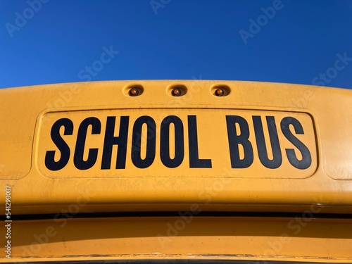 School bus sign on yellow school bus. Close up.