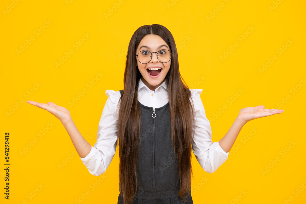 Portrait of joyful child girl with raised hands. Caucasian teenager screaming isolated on yellow. Happy child exclaiming with joy and excitement. Excited face, cheerful emotions of teenager girl. Portrait of joyful child girl with raised hands. Caucasian teenager screaming isolated on yellow. Happy child exclaiming with joy and excitement. Excited face, cheerful emotions of teenager girl.