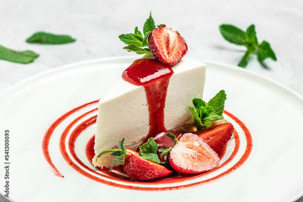 Strawberry Cheesecake with Strawberry Syrup. piece of cheesecake decorated with strawberry sauce on white background
