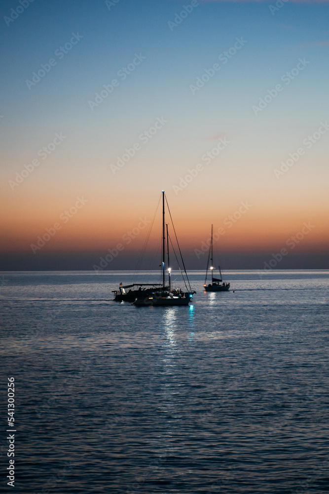 yachts in the night sea against the backdrop of sunset