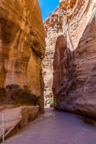 A view of a narrow passage in the gorge on the approach to the ancient city of Petra, Jordan in summertime