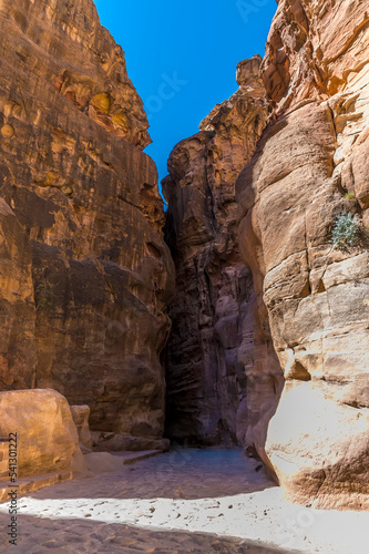 A view of a narrow opening in the gorge on the approach to the ancient city of Petra, Jordan in summertime