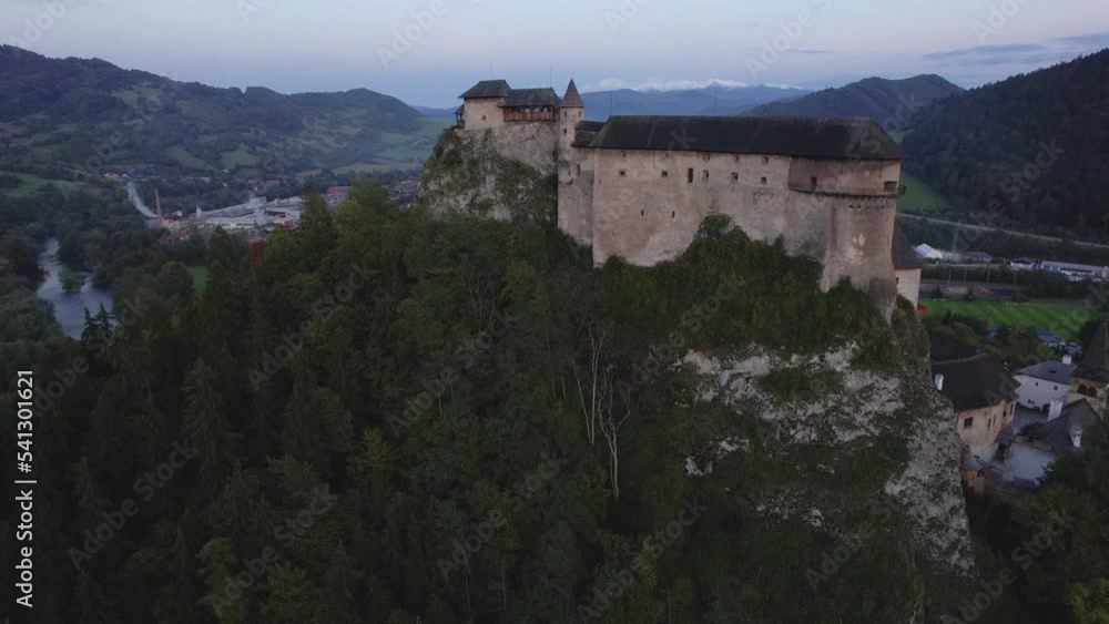 Medieval castle on a hilltop overlooking a village Medieval castle on a hilltop overlooking a village