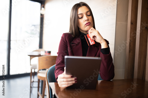Business woman hands holding credit card and using tablet 