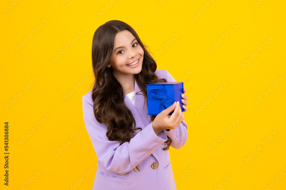 Child with gift present box on isolated background. Presents for birthday, Valentines day, New Year or Christmas. Happy teenager, positive and smiling emotions of teen girl. Child with gift present box on isolated background. Presents for birthday, Valentines day, New Year or Christmas. Happy teenager, positive and smiling emotions of teen girl.