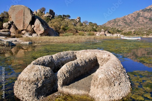 Landscape around Lake Bafa in Turkey, with ancient tombs near the water.