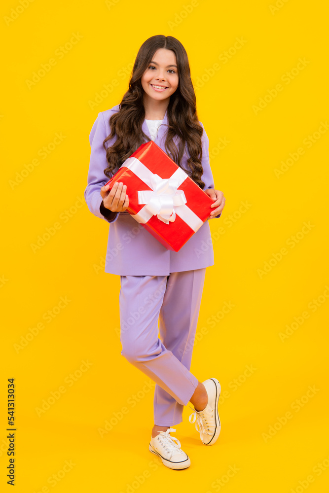 Teenager kid with present box. Teen child girl giving birthday gift. Present, greeting and gifting concept. Teenager kid with present box. Teen child girl giving birthday gift. Present, greeting and gifting concept.