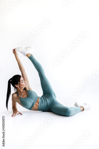 Fitness woman stretching full body. Fitness woman standing stretching thigh in full body on white background.