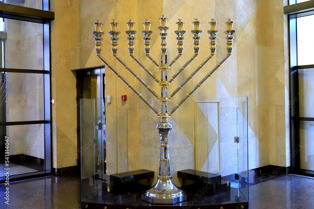 Golden Hanukkah menorah in the synagogue for Jewish holiday. Ancient ritual religious menorah candle.