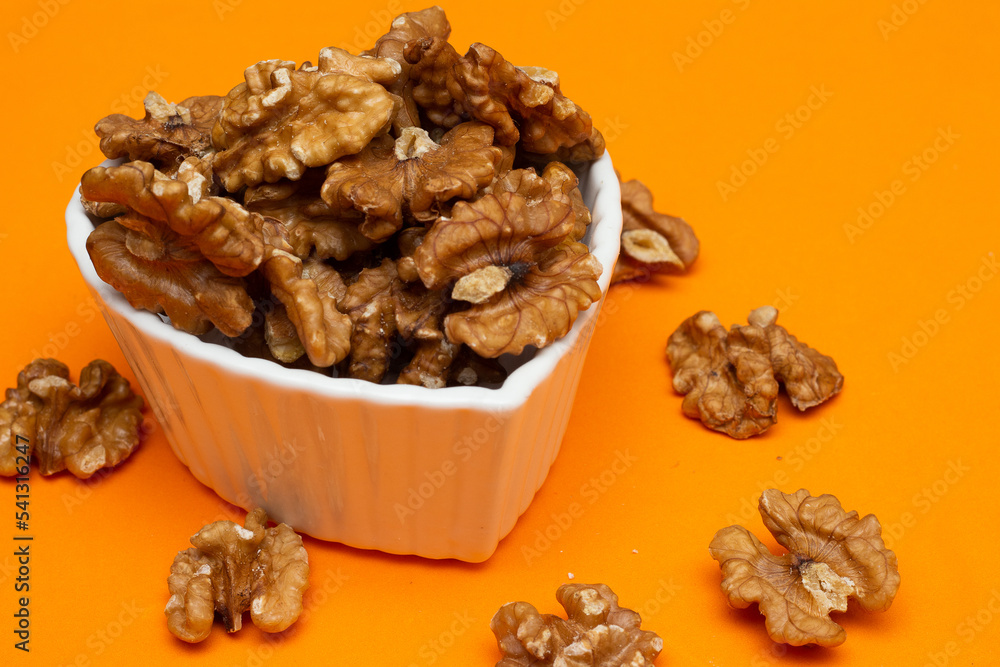bowl full of almonds on a colored background