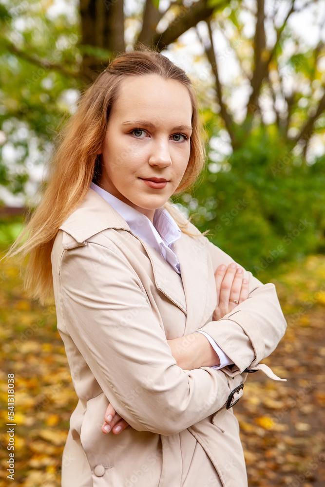 Cute girl on autumn day against background of yellow leaves Cute girl on autumn day against background of yellow leaves