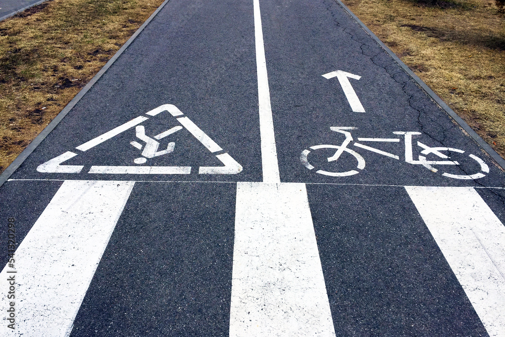 Fototapeta premium Signs of Bicycle Lane and Pedestrian Path and Crosswalk Zebra.