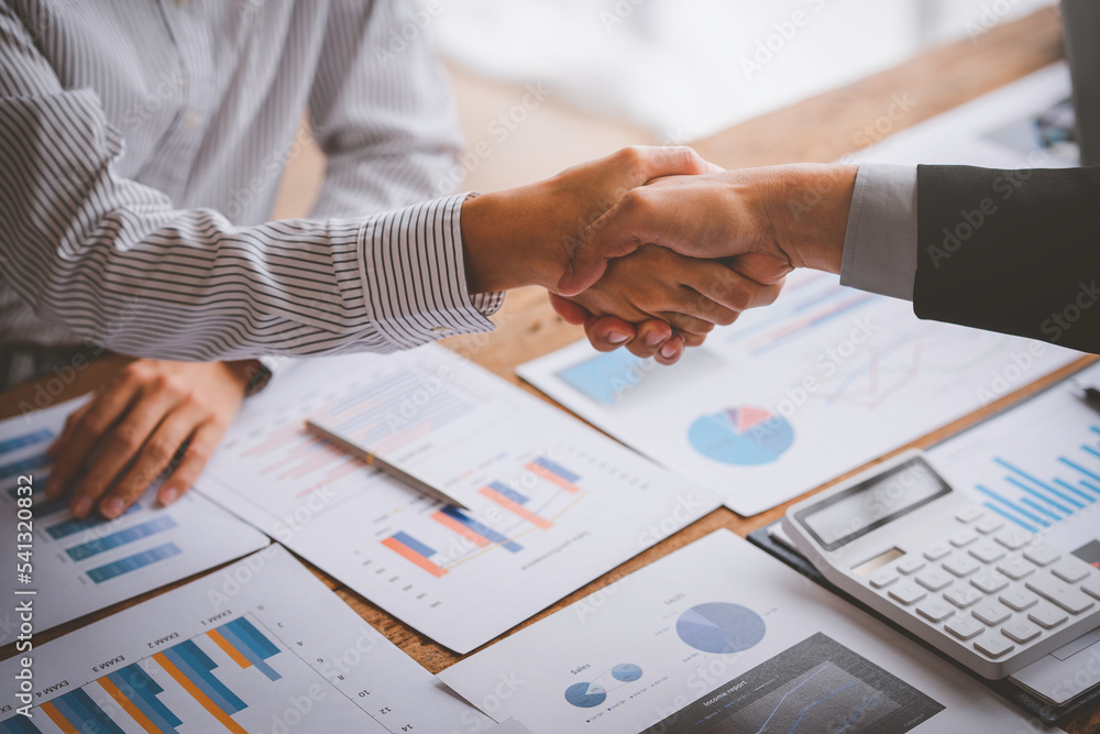 Young businesspeople shaking hands in the office, Finishing successful meetings, a handshake of business people deal business, Teamwork