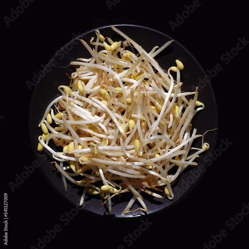 Fresh soy bean sprouts on a black plate