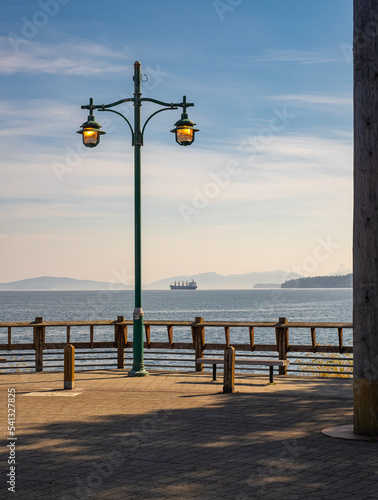 Glowing street lamp at the harbour in Vancouver Island. View from the pier.
