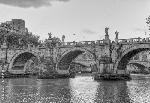 A view of the Saint Angelo bridge during the fall spanning the Tiber river in Rome Italy.