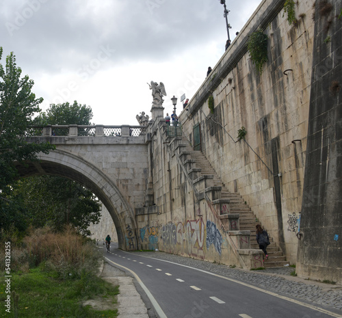 A view of the Saint Angelo bridge during the fall spanning the Tiber river in Rome Italy. photo