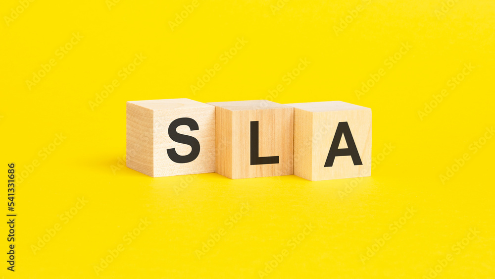 sla - text on wooden cubes, on yellow background. Service Level Agreement concept sla - text on wooden cubes, on yellow background. Service Level Agreement concept