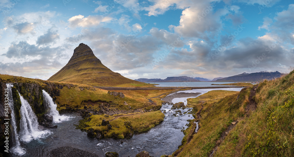 Fototapeta premium Famous picturesque Kirkjufell mountain and Kirkjufellsfoss waterfall next to Grundarfjordur at West Iceland autumn view.
