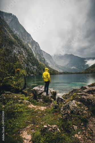 hiker in front of mountain lake obersee in germany