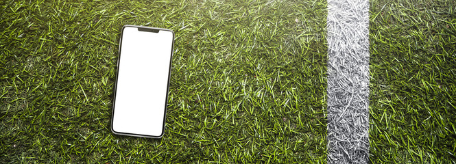 smartphone on the grass of a american football stadium / soccer