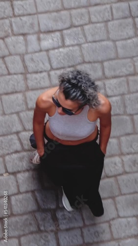 aerial view of short-haired woman walking on steep road	
