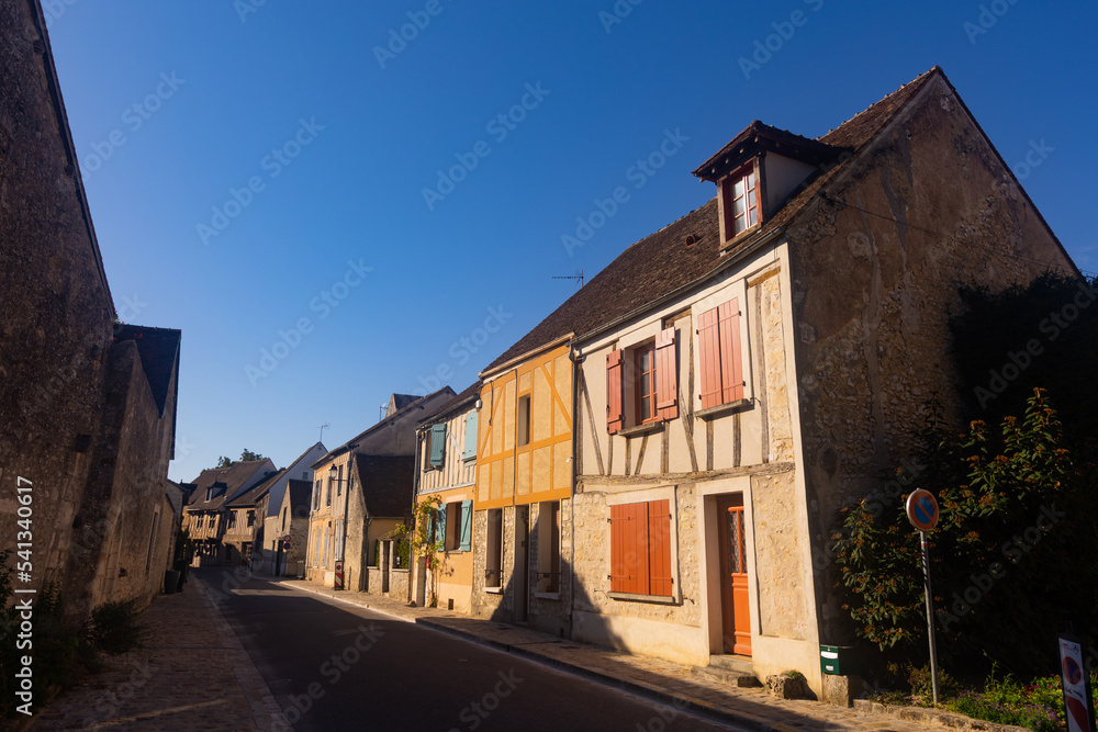 View of ancient half-timbered residential houses in old town of Provins on sunny summer day, France..