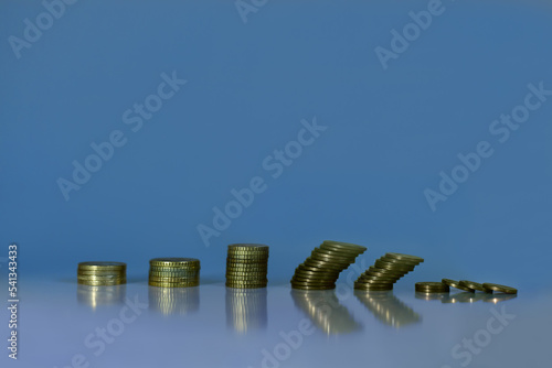View of coins stacks decreasing. Inflation, Economic crisis, Recession and Business crisis  concept. 
