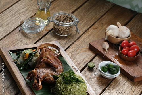 Kampung fried chicken with basil rice, served with urap and sambal matah.