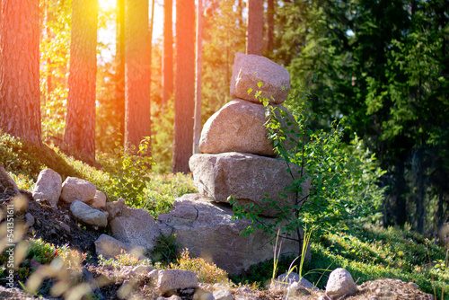 Close-up of stone structures, cairns in the forest on the territory of Russia in Karelia against the backdrop of sunset