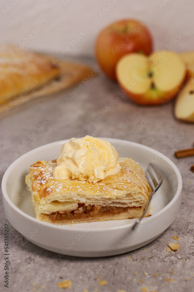 piece of an apple strudel roll with cinnamon and ice cream on top piece of an apple strudel roll with cinnamon and ice cream on top