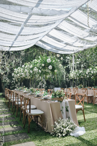 Ornamental decorations with multi flora. Outdoors light. Wedding ceremony or wedding decoration with clear tent in the sunny afternoon natural lights. photo