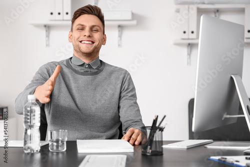 Young businessman reaching ...