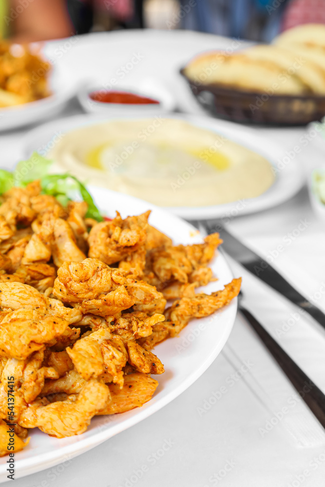 Plates with tasty food on table in restaurant, closeup Plates with tasty food on table in restaurant, closeup