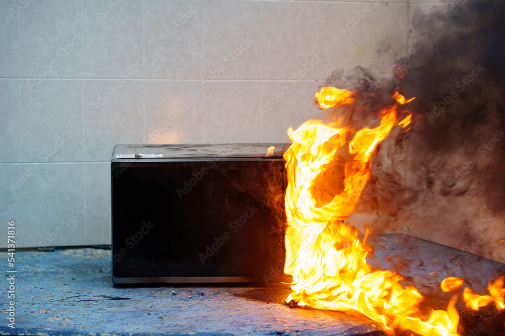 microwave oven on fire. the concept of fire in the kitchen and