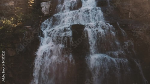 Aerial footage of lower Morrell Falls with the spray and light shining through photo