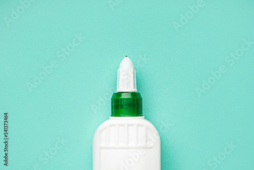 Bottle of glue on color background