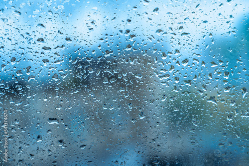 Rainy background, rain drops on the window, autumn season backdrop, abstract textured wallpaper. Raindrops on transparent window